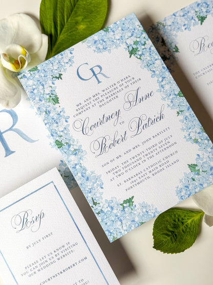 Blue floral watercolor wedding invitation with script names and CR monogram in blue