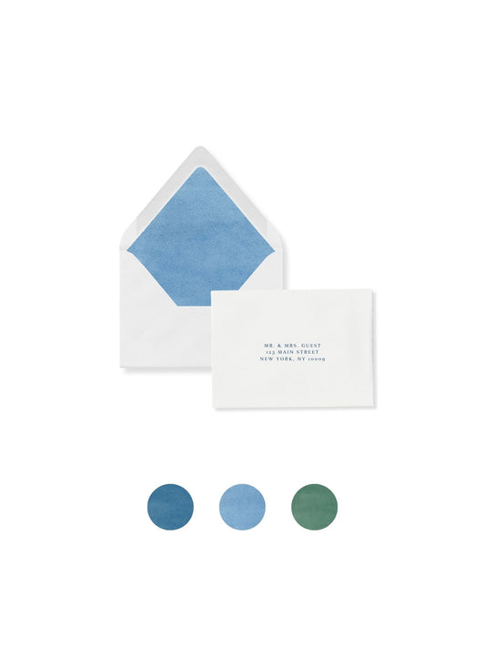 RSVP envelope with ocean-blue liner, flap open; guest card with printed names and address