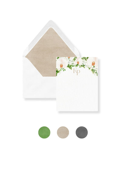 White stationery envelope set with floral monogram Kp and green liner swatch