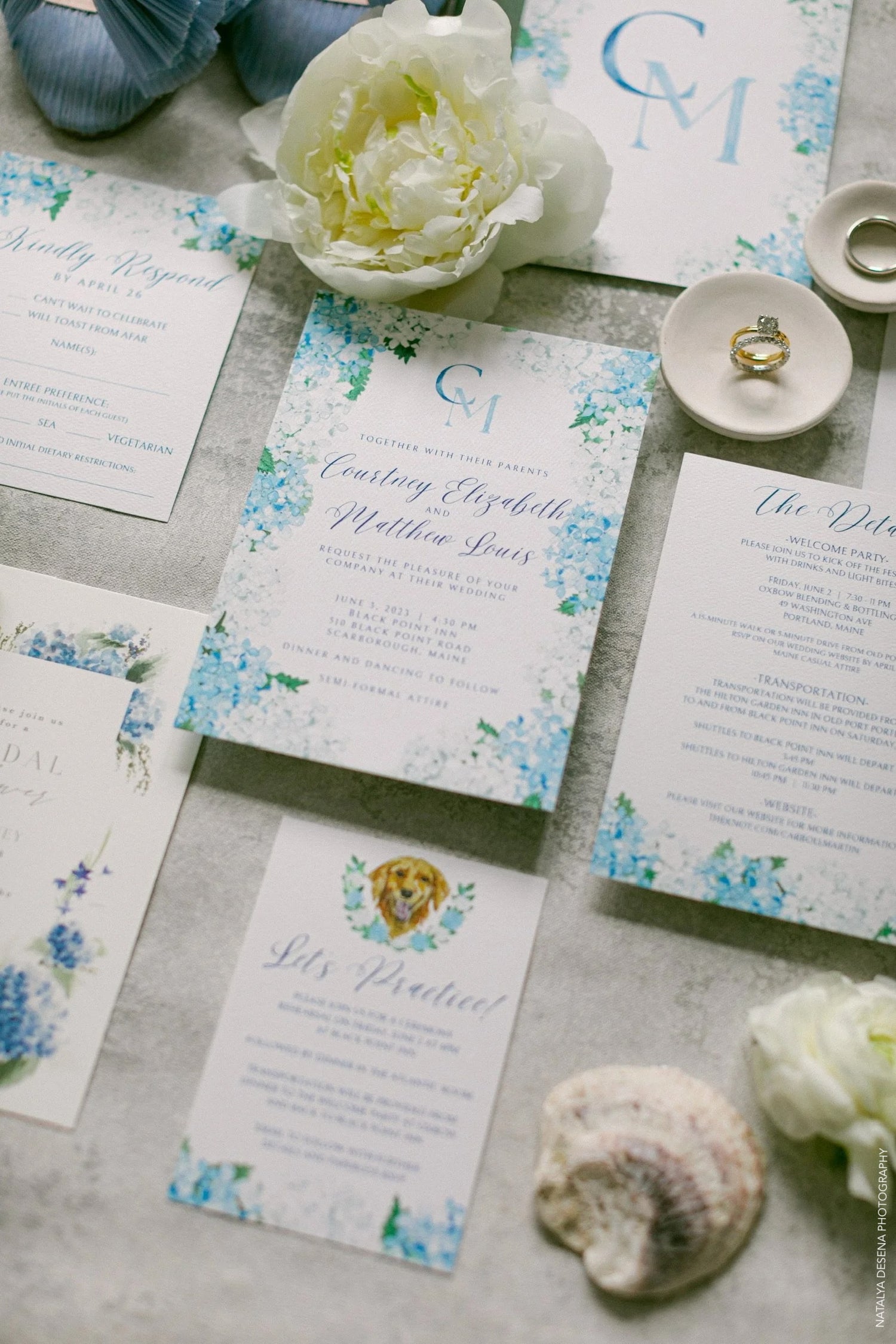 Bespoke wedding invitation set with floral hydrangea design, custom dog illustration, and 'C' and 'M' monogram.