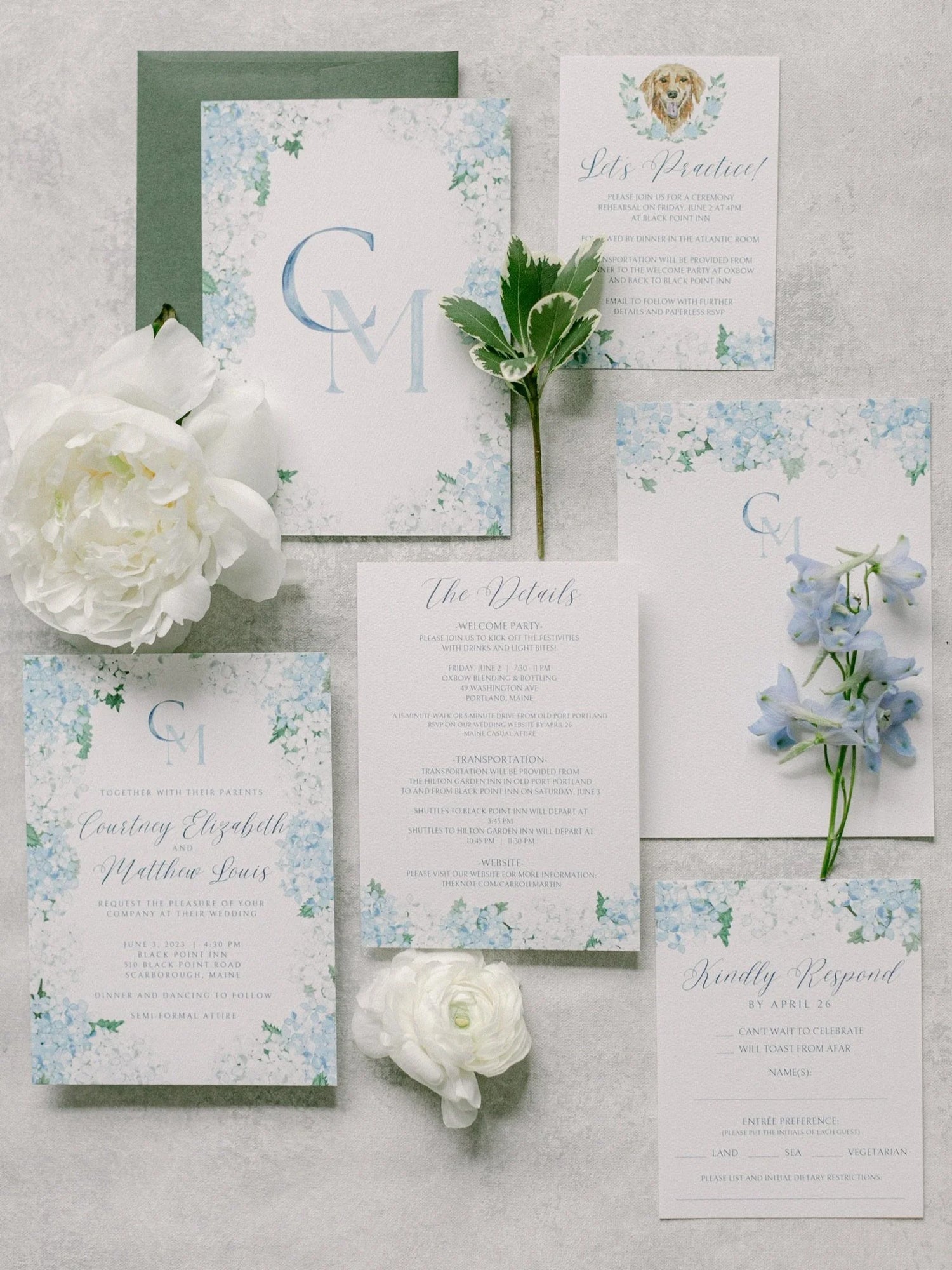 Wedding invitation set with floral designs and white flowers on a gray background