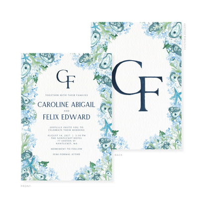 Wedding invitation front with blue monogram GF and watercolor floral frame; back card partly visible