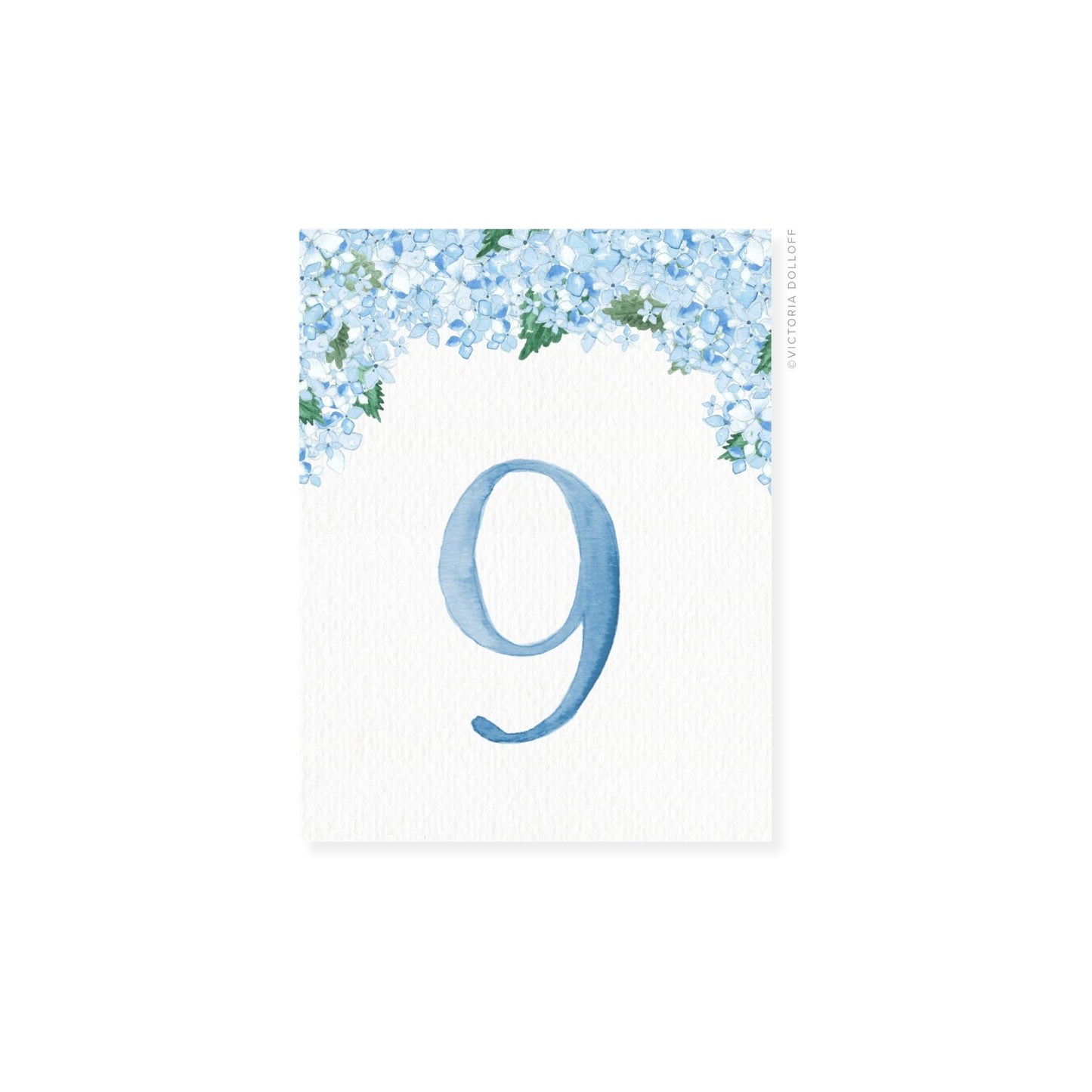 Table number 9 in blue with blue floral border and greenery arch