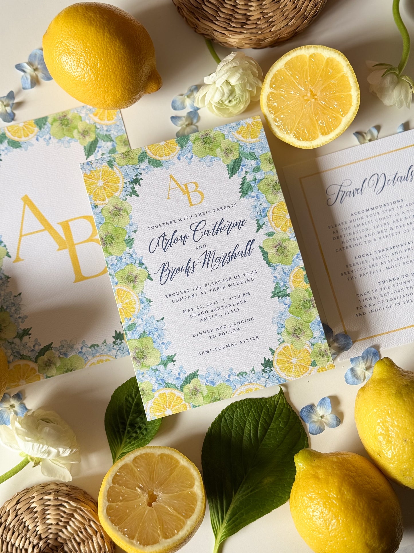Overhead view of watercolor wedding invitation set with gold initials AB and lemon border
