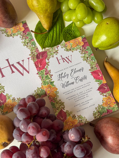 Watercolor wedding invitation with floral border, burgundy HW monogram, and wedding details