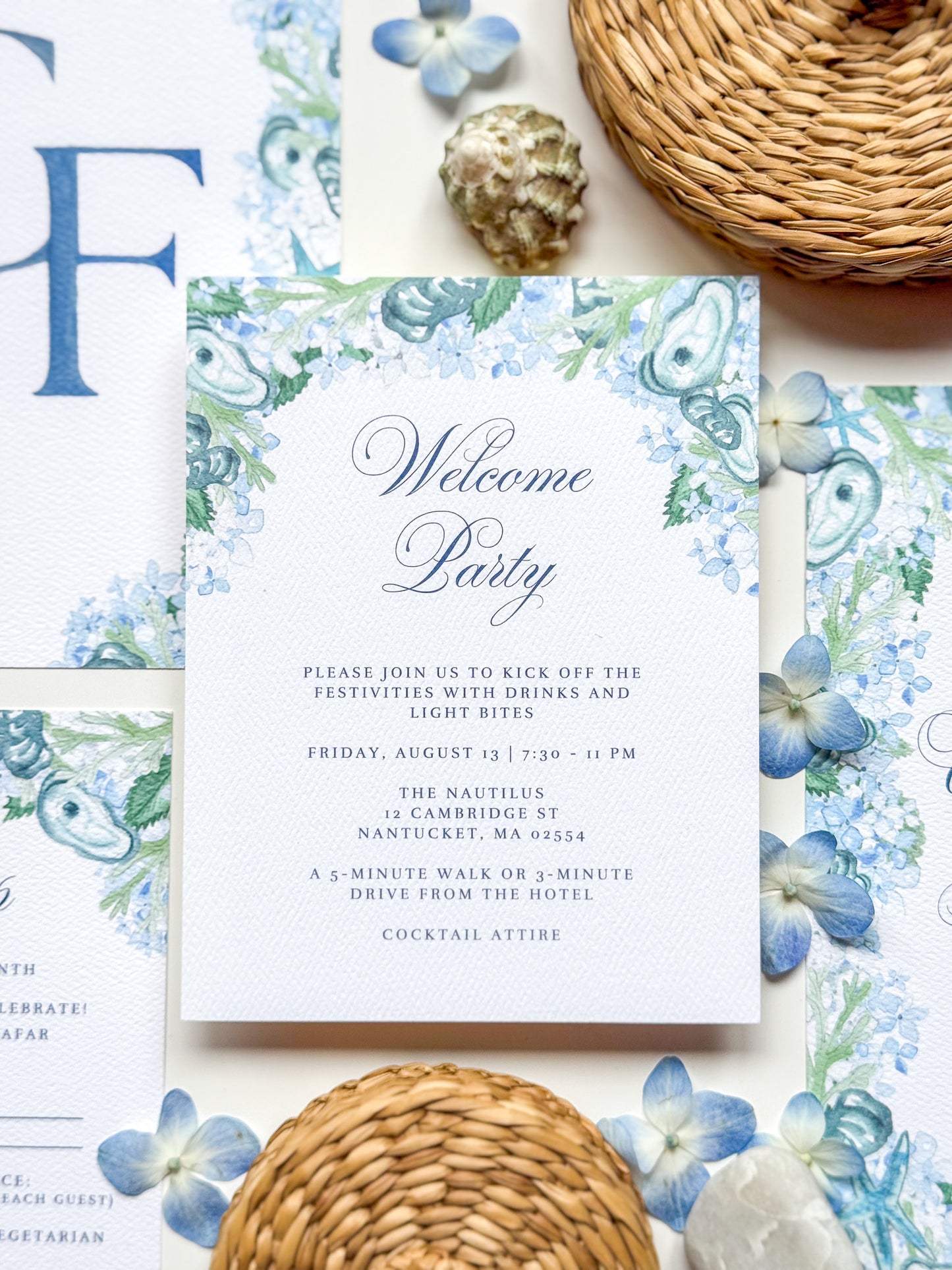 Oyster watercolor floral enclosure card with navy script “Welcome Party”