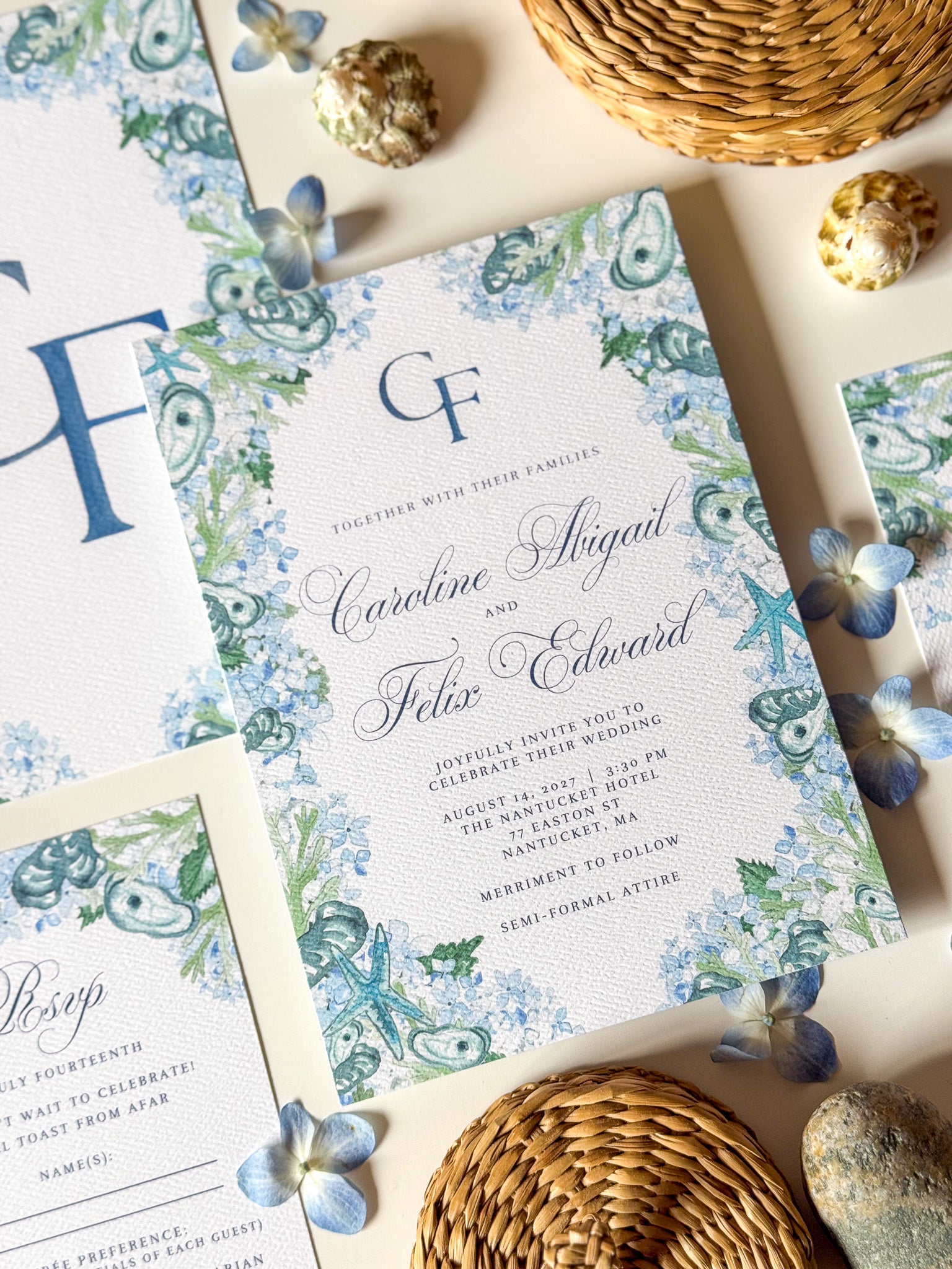 Watercolor wedding invitation with blue floral border and monogram CF, names and date